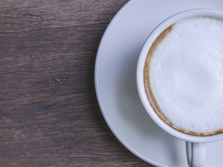 cappuccino coffee on wooden tableの写真素材