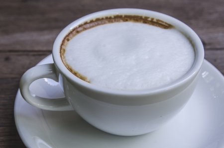 cappuccino coffee on wooden tableの写真素材