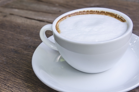 cappuccino coffee on wooden tableの写真素材