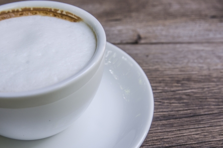 cappuccino coffee on wooden tableの写真素材