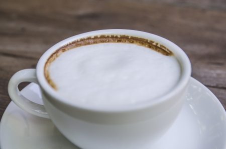 cappuccino coffee on wooden tableの写真素材
