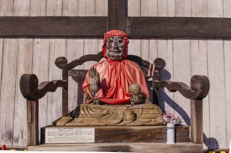 The wooden buddha with red coat at Todiaji temple, nara, japanのeditorial素材