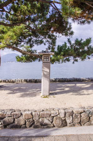 Japanese stone lanterns at miyajima, japan.の写真素材