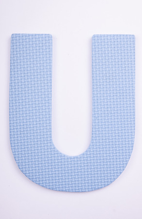 alphabet U made from foam on white isolatedの写真素材