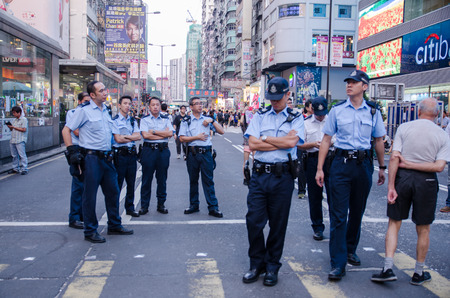 HONG KONG, OCT 16: Hongkong police bewara a many protesters in Mong Kok on 16 October 2014. during Umbrella revolution, they will control protest do not make illegal.のeditorial素材