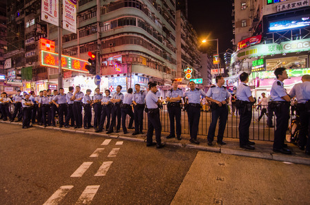HONG KONG, OCT 16: Hongkong police bewara a many protesters in Mong Kok on 16 October 2014. during Umbrella revolution, they will control protest do not make illegal.のeditorial素材