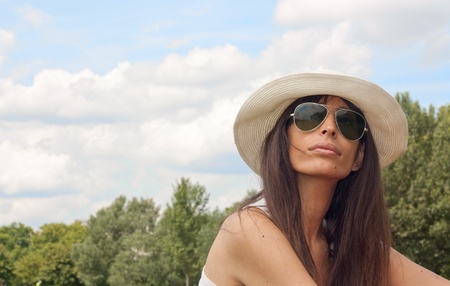 Beautiful woman in a park on a summer dayの写真素材