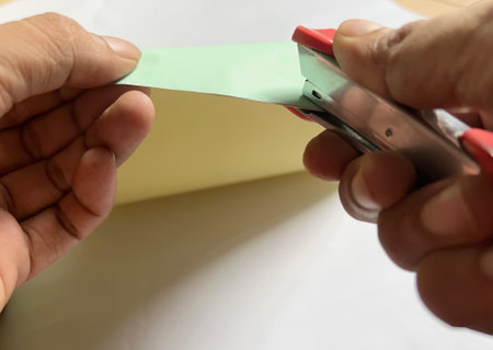 hand holding staples for paperの写真素材