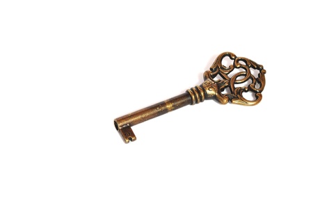 Beautiful bronze key isolated on a white background with space for text writingの写真素材