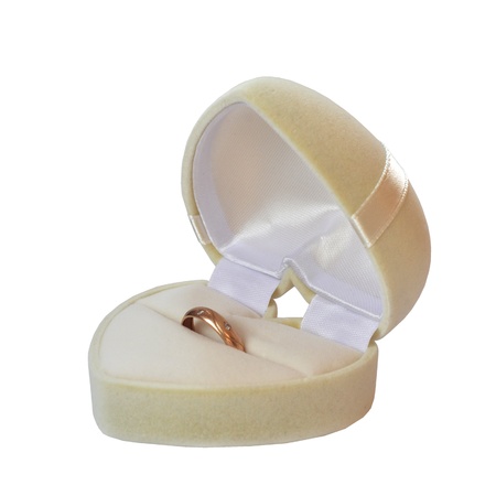 Box in the form of a white heart with wedding ring isolated on white backgroundの写真素材