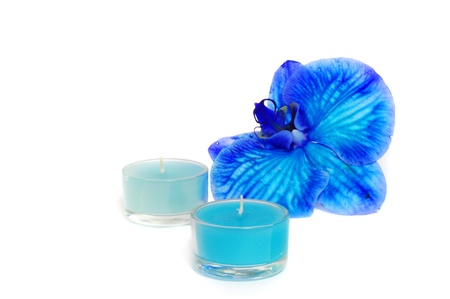 Two candles and blue orchid isolated on white backgroundの写真素材