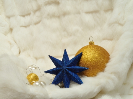 Christmas Decorations: star, balls and pearls on white fur with space for text writingの写真素材