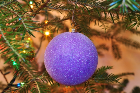 New Year background, Christmas tree with purple ball and sparkling garlandsの写真素材