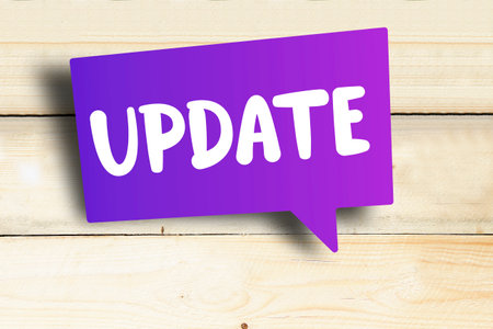 update purple speech bubble on wooden backgroundの写真素材