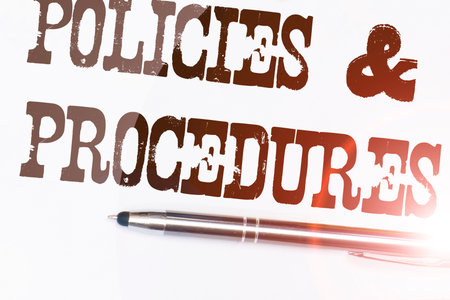 Policies and procedures memo on notebook with penの写真素材