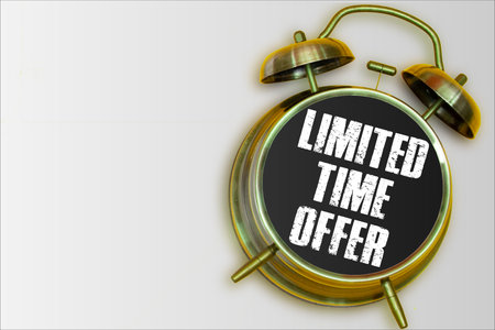 Limited time offer yellow alarm clock on grey backgroundの写真素材