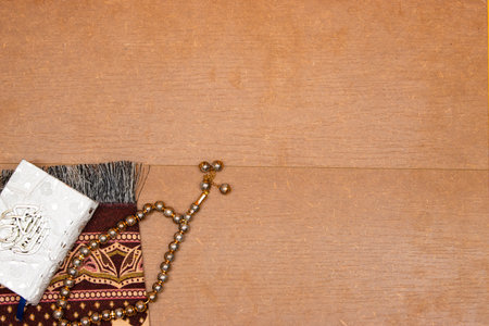 quran islamic book, Rosary or prayer beads and Muslim prayer rug on wooden backgroundの写真素材