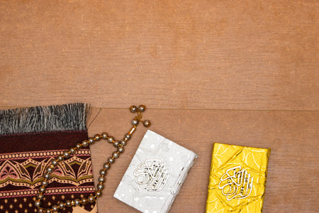 quran islamic book, Rosary or prayer beads and Muslim prayer rug on wooden backgroundの写真素材