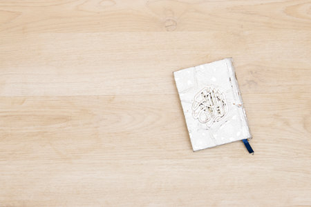 Holy Quran with Arabic calligraphy on wooden background