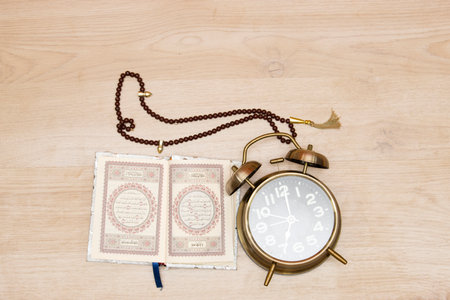 Koran and rosary beads on the wooden background for Islamic concept. Holy book quran for Muslims holiday, Ramadan,blessed Friday message and three monthsの写真素材