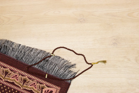 quran islamic book, Rosary or prayer beads and Muslim prayer rug on wooden backgroundの写真素材