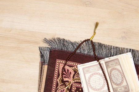 quran islamic book, Rosary or prayer beads and Muslim prayer rug on wooden backgroundの写真素材
