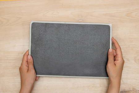 woman's hands holding a blackboard publicityの写真素材