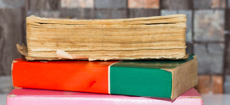 Work place table with stacks of real books on it as bannerの写真素材