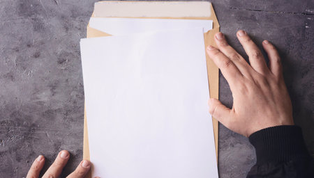 Hand opening brown Document Envelope with copy spaceの写真素材