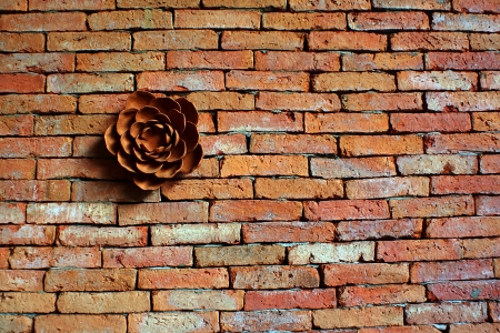 The terracotta flower on the brick wallの写真素材
