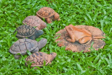 A pottery of frog and turtles on the yardの写真素材