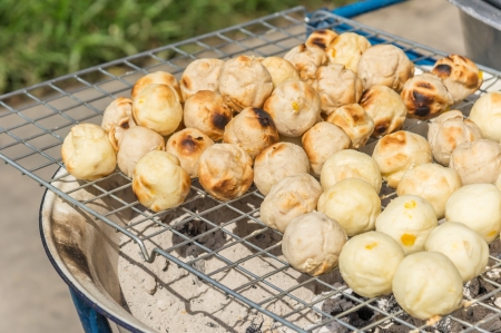 Sweet grinded cassava place on sieve toast by burning chacoalの写真素材
