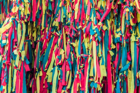 Colourful peaces of clothes be bind together on tree by people who belived this will exorcise their fateの写真素材