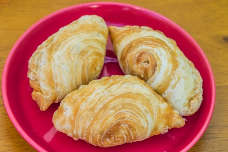 Curry puff,a kind of sweet in Thailand,place on the red plate