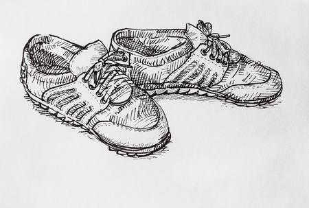 Hand drawing  a pair of shoe by black ink on white paperの写真素材