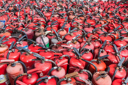 Background with a lot of used fire extinguishersの写真素材