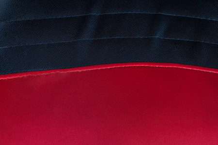 Close up red-black leather of chair for use as backgroundの写真素材