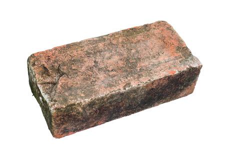 Single old red brick with moss on white backgroundの写真素材