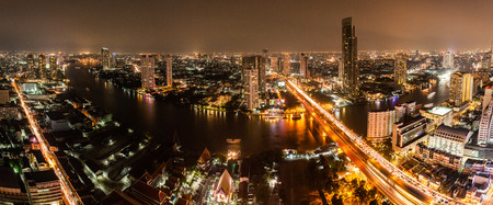 High view of Bangkok city with modern building and traffic at nigh along Chaopraya riverのeditorial素材