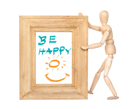 Wooden figure hold square wooden frame with happy smile inside isolated on whiteの写真素材