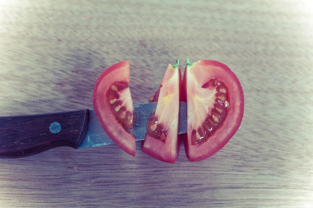 Cleave of red potato,look like heart shape,stabbed by knife on woodeb board.love conceptの写真素材