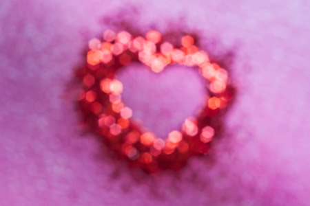 Blur of red bokeh with heart shape inside on pink background,valentine conceptの写真素材