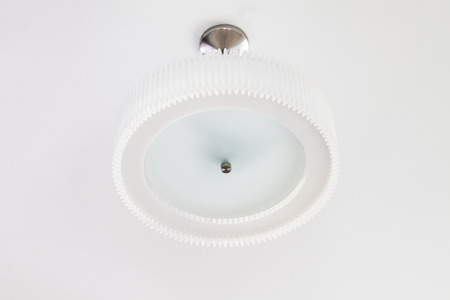 Ceiling lamp hang on red white wall backgroundの写真素材
