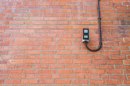 Background of old brown vintage brick wall with led spotlightの写真素材