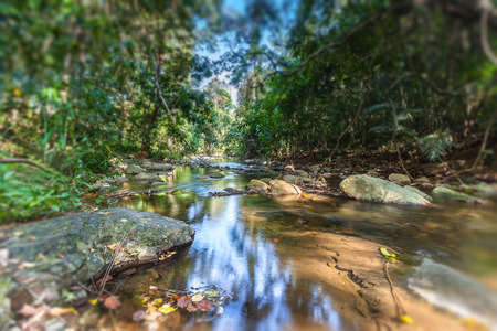 Nature small waterfall with rock in Thailand,clearly at center
