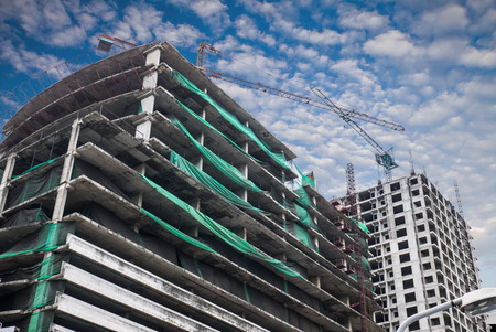 Construction site with crane and building and blue skyの写真素材