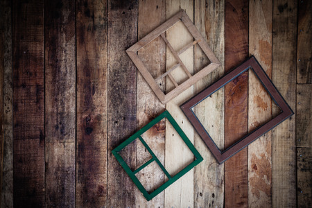 Empty wooden frame for photographer or painting hang on wooden wall
