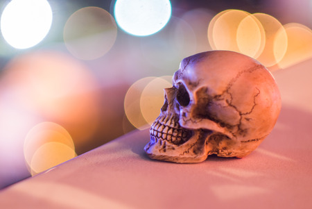Skull on cement wall with light bokeh backgroundの写真素材
