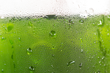 Water drop on bottle of green drink for use as backgroundの写真素材