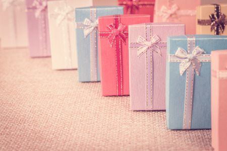 Small gift box set on sack cloth background,vintage tone